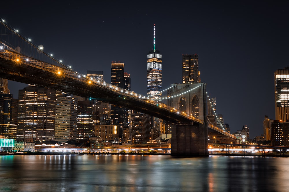 a bridge over a river with a city in the background