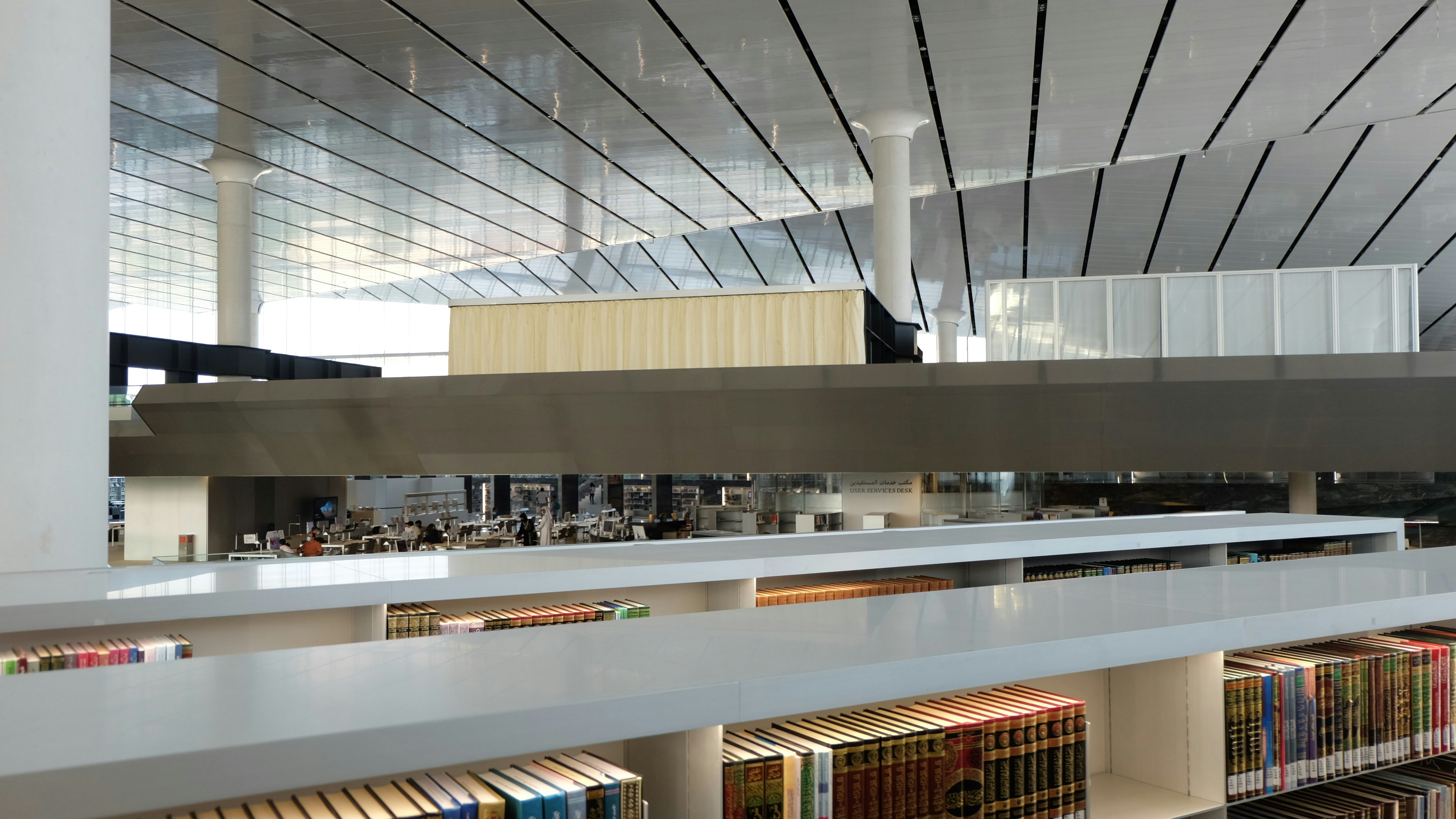 A library with books on shelves photo Free Qatar Image on Unsplash