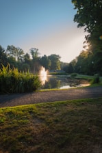 A serene photo of a quiet city park bathed in soft morning light, evoking calm and reflection.