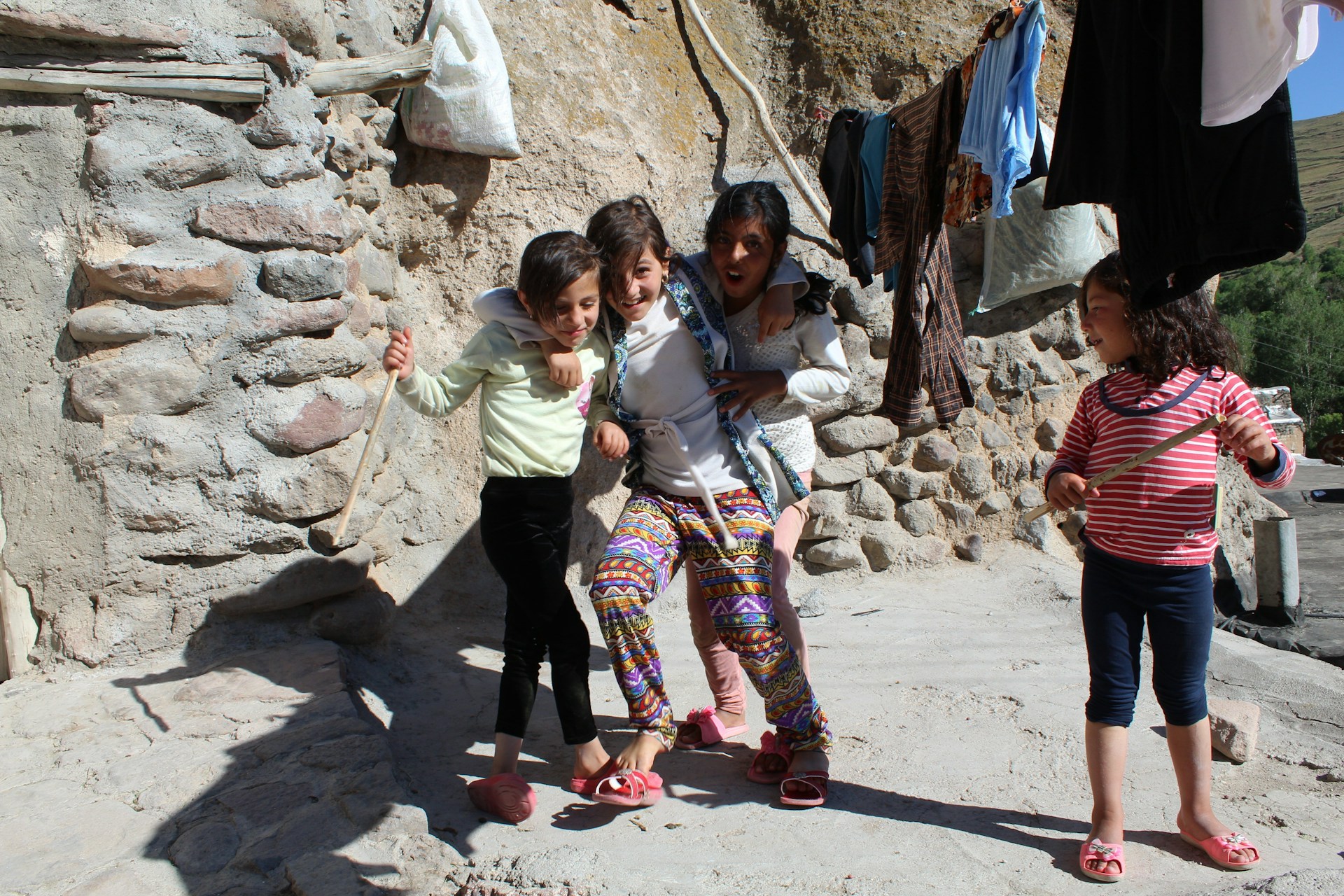 A candid moment of children playing together in the backyard on a sunny afternoon.