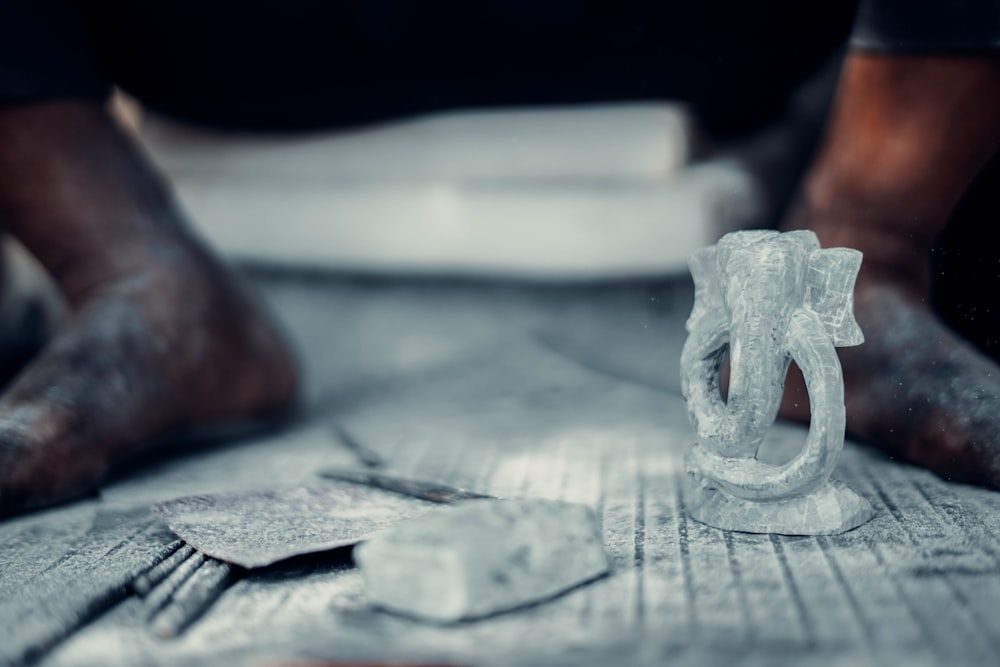 a person's feet on a table with a model of a human skull