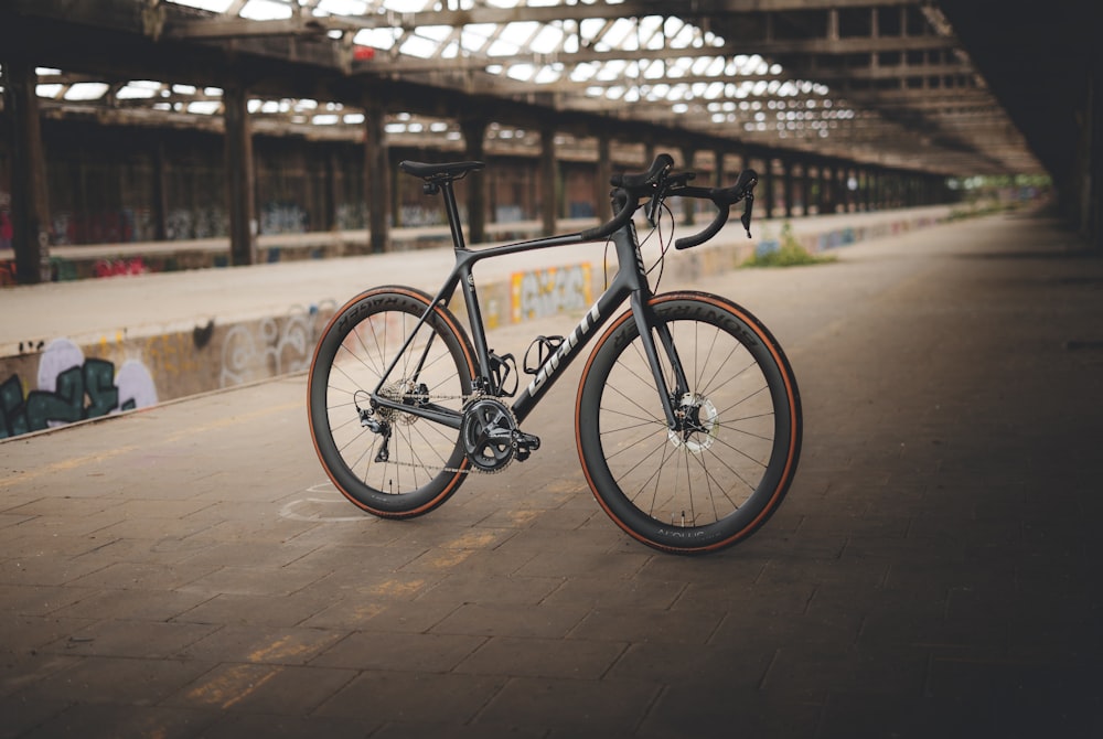 a bicycle parked on a wooden surface