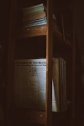 A dimly lit room with a vintage microphone and old books about legends.