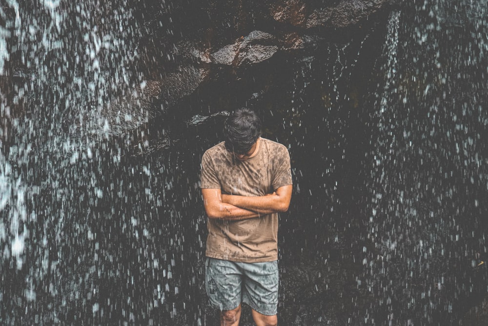 a man standing in front of a wall of water
