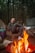 A happy customer using Bairagi Couple's camping gear in a scenic outdoor setting.