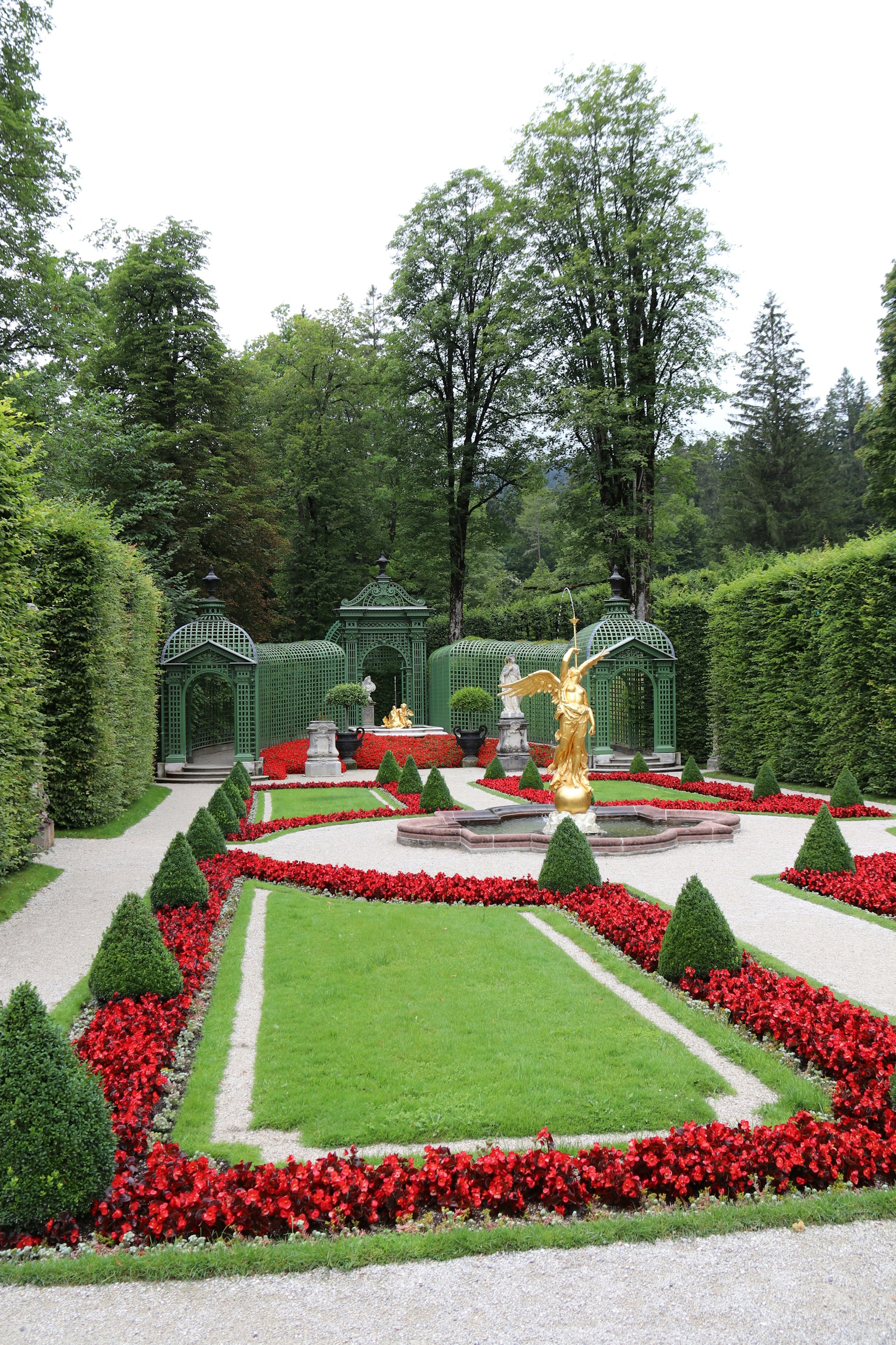 a garden with a statue in the center