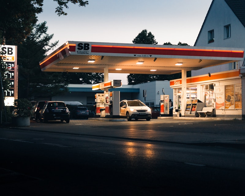 Modern gas station forecourt with bright canopy lighting
