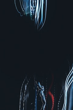 An abstract representation of AI composing music with colorful light trails.