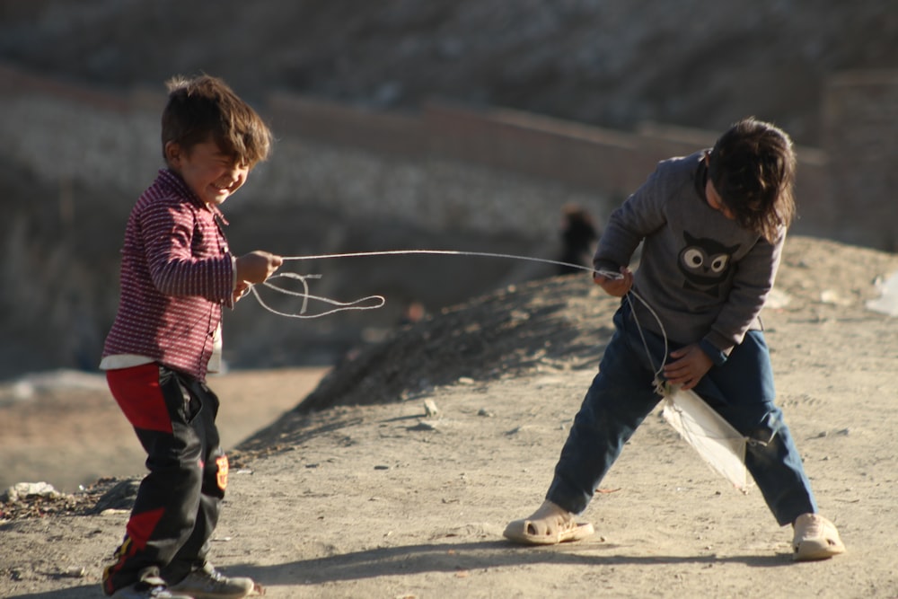 a couple of kids playing with a bow and arrow