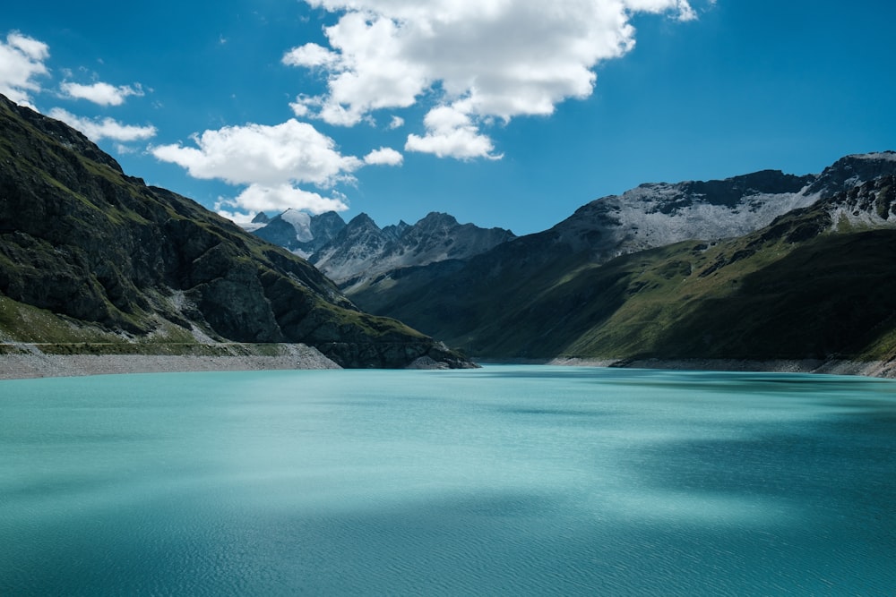 a body of water with mountains in the back