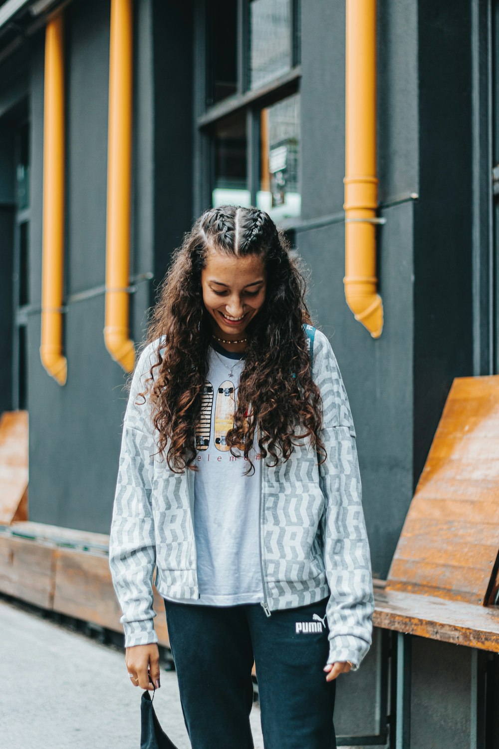 a woman walking down a sidewalk