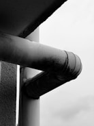 Before and after images showing heavy scale buildup on a water heater pipe and the same pipe clean after Urjon Water Pulser treatment