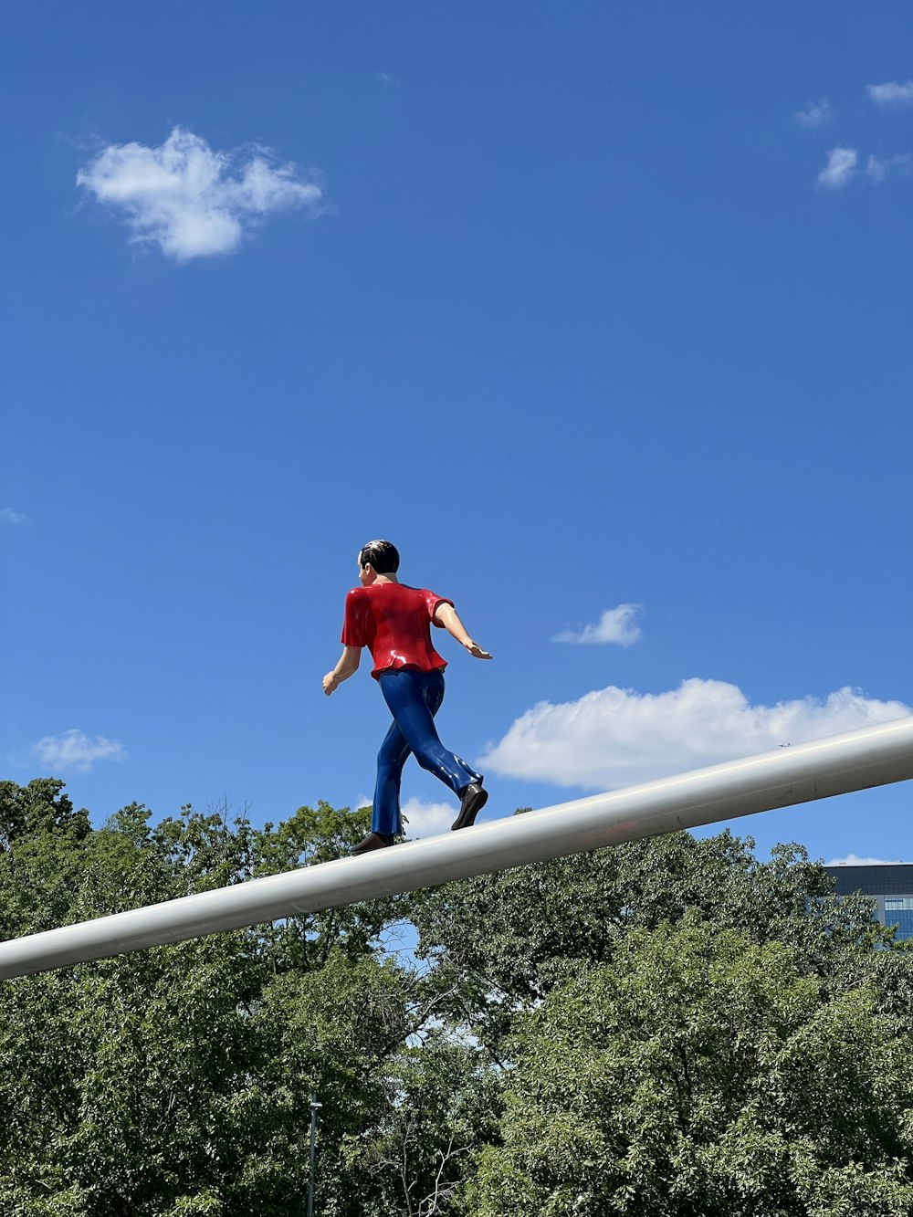 a man jumping off a metal pole