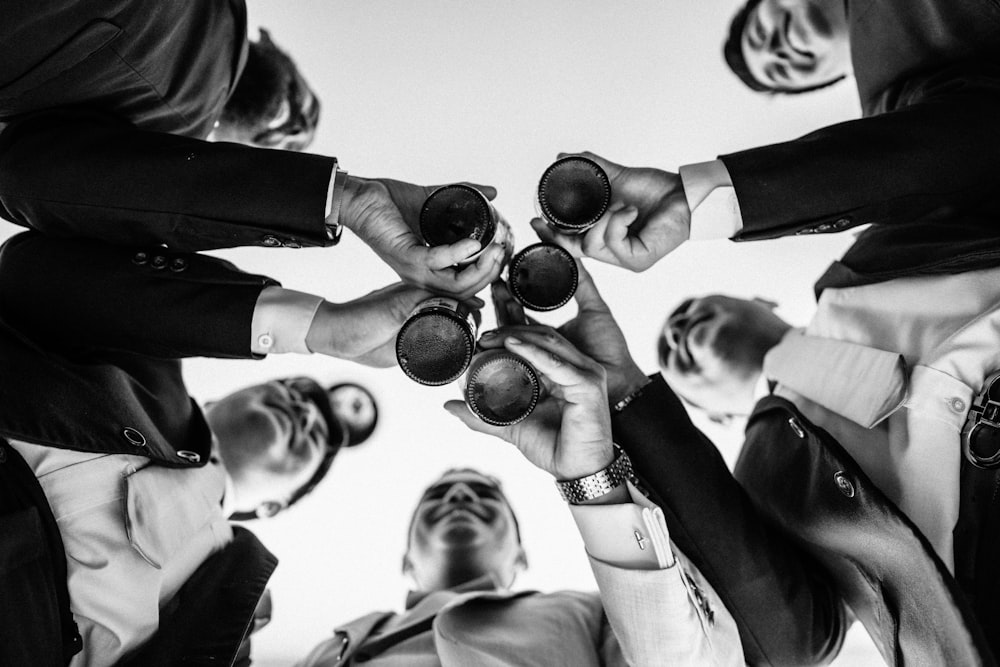 a group of people holding wine glasses