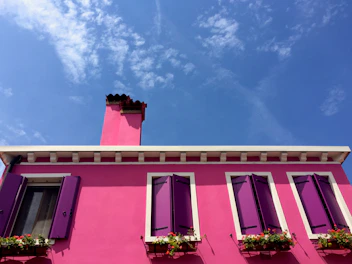 A vibrant wendy house painted in bright colors, showcasing customization options.