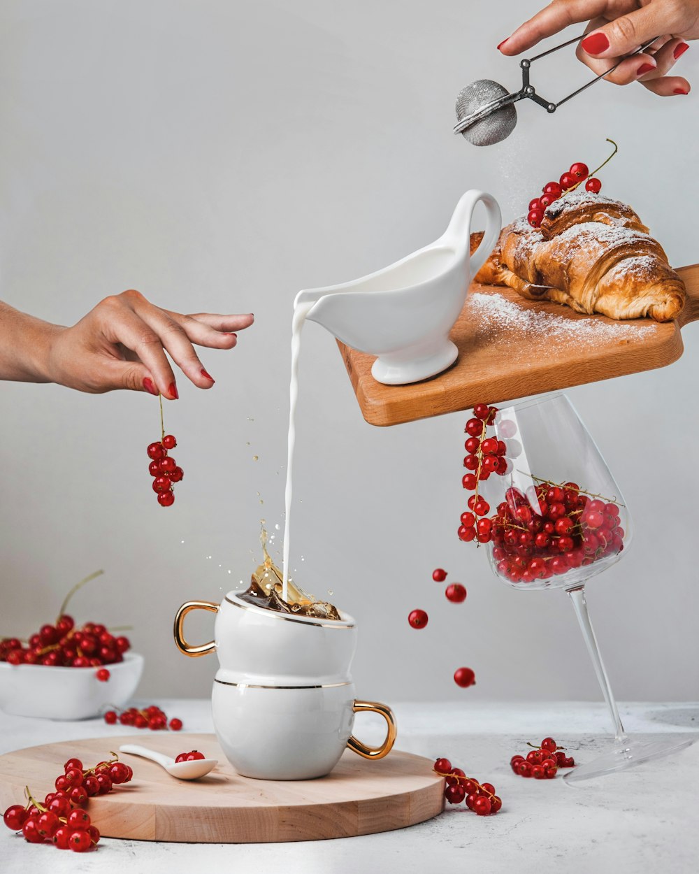 a person pouring a tea into a teapot