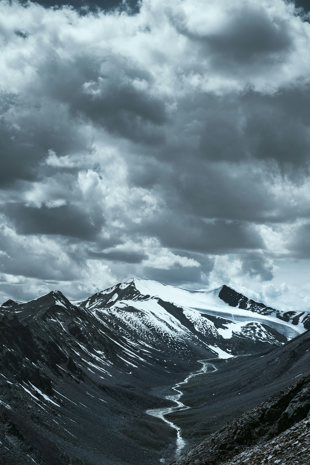 a mountain with clouds above it