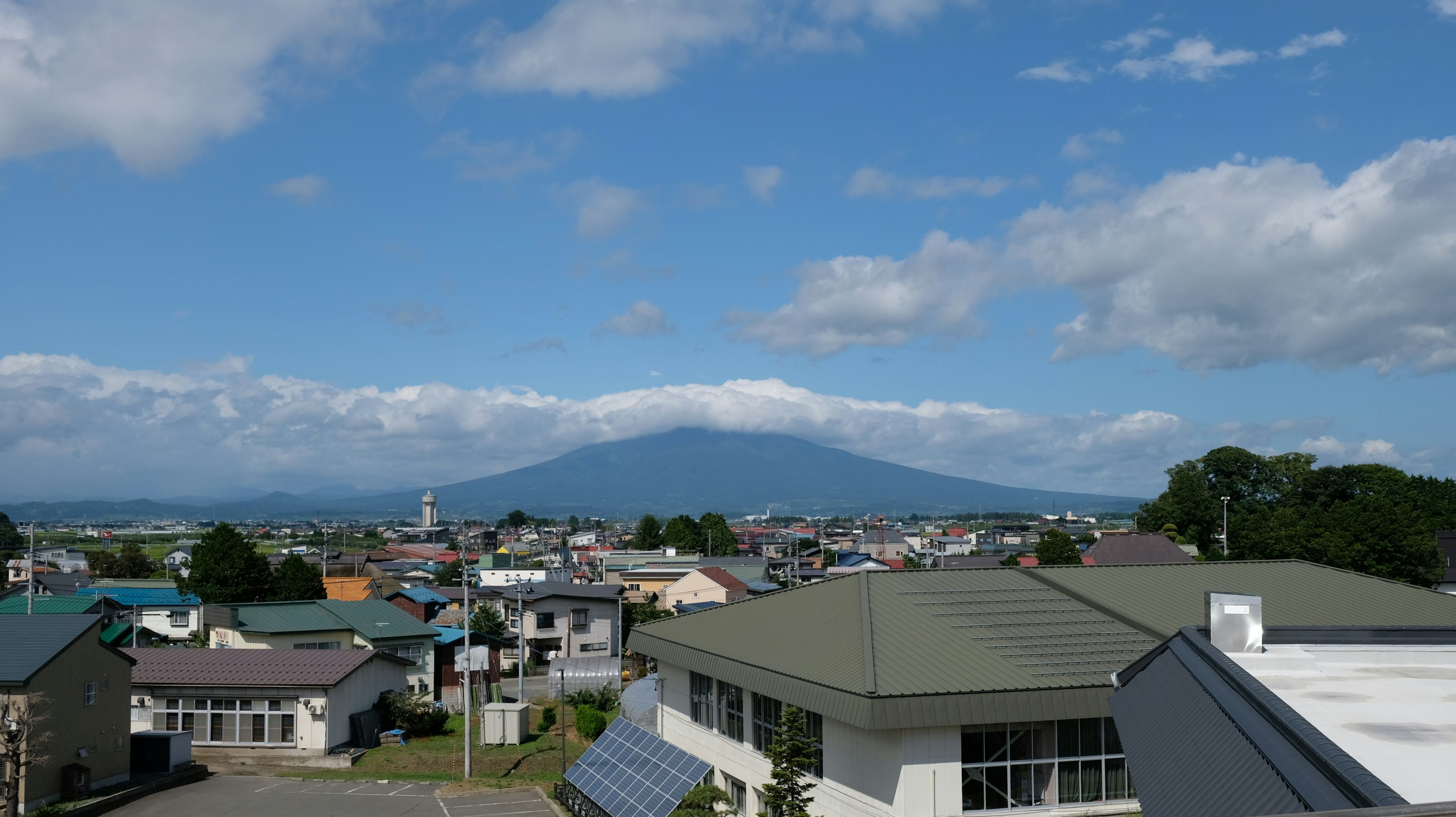 a group of buildings with a mountain in the background