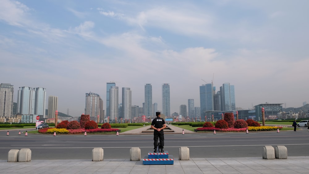 a person standing on a platform in front of a city