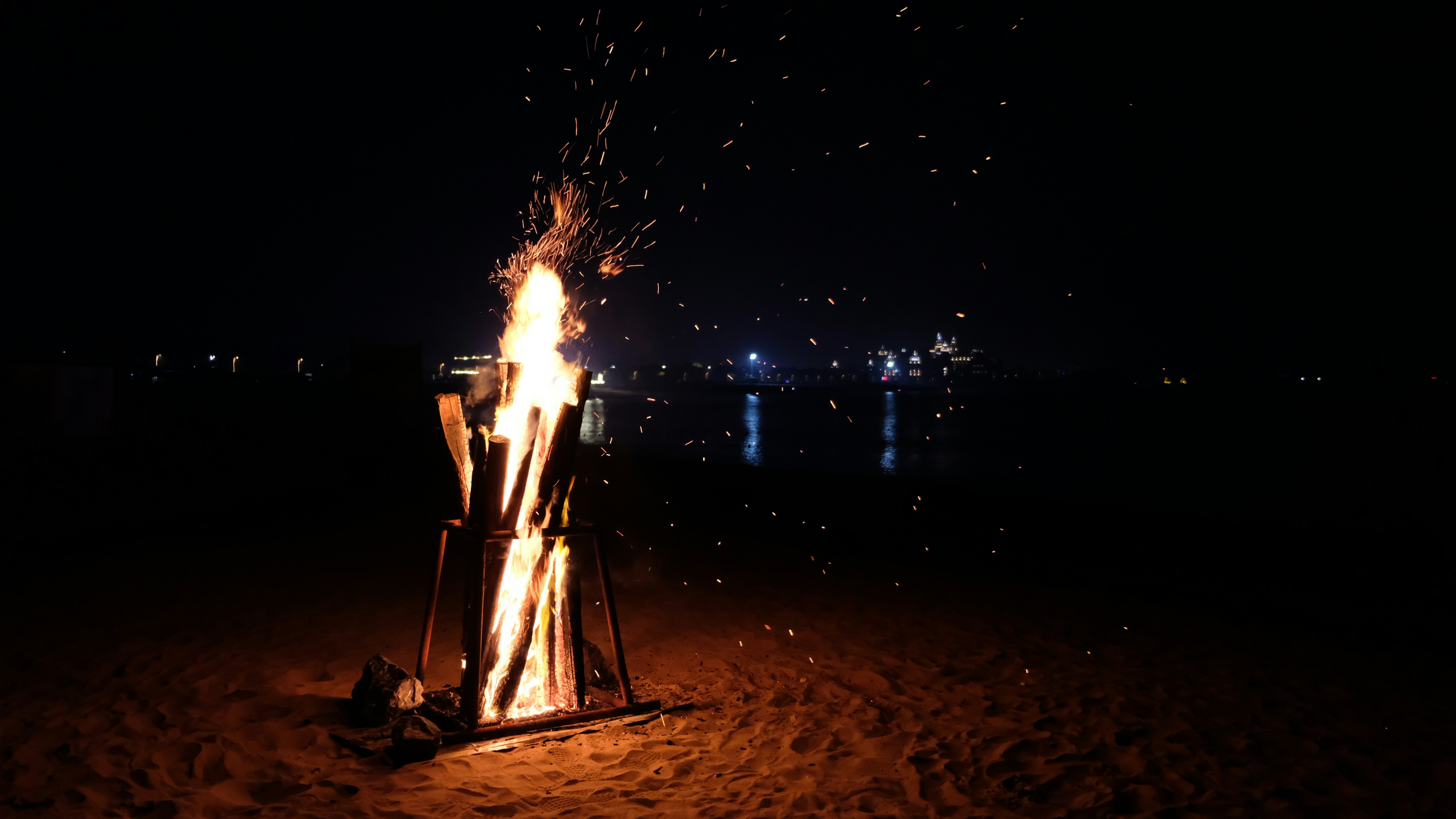 a fire on a beach at night