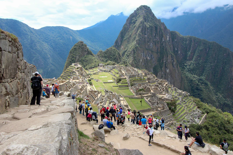 A group of travellers on a mountain above Machu Picchu