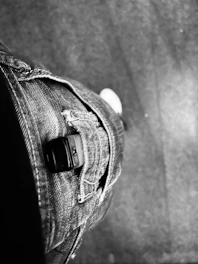 Close-up of cargo jeans with multiple pockets in an urban environment.