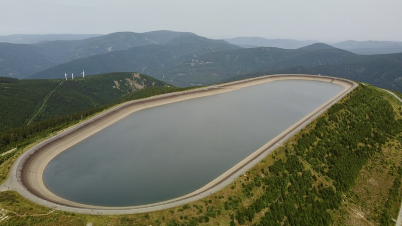 A large dam with a river running through it