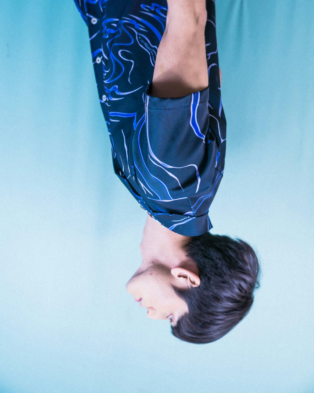 a boy wearing a blue and white striped shirt