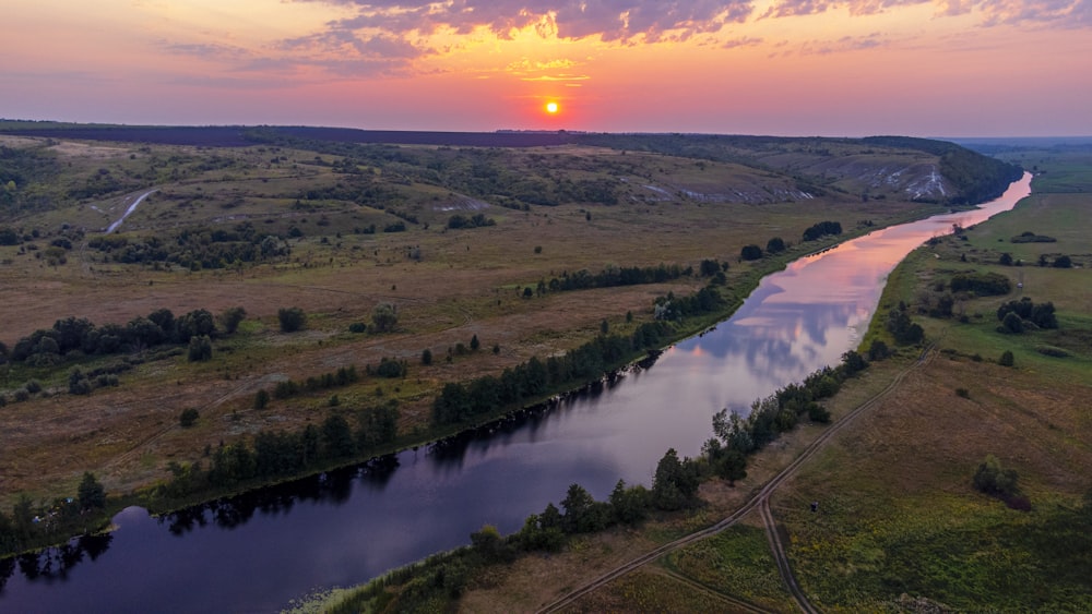 a river with a sunset in the background