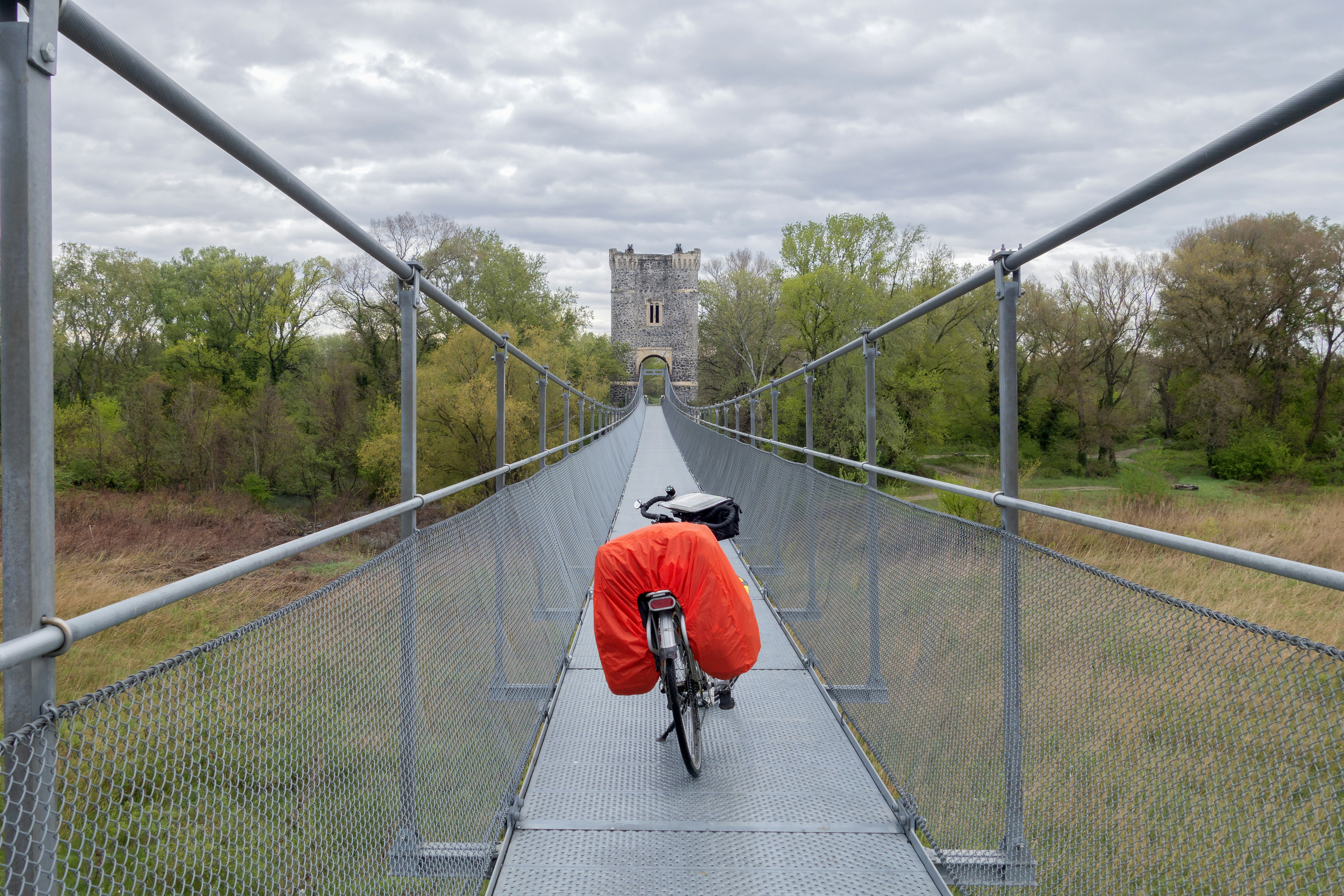 a person riding a bike on a bridge, 