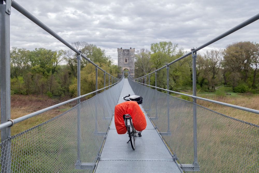 a person riding a bike on a bridge