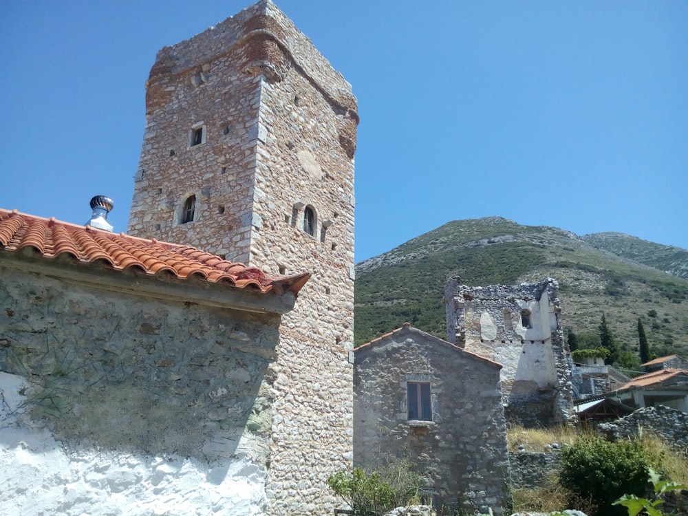 a stone building with a red roof