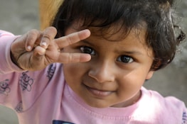 A joyful child communicating with a support teacher using visual aids and gestures.