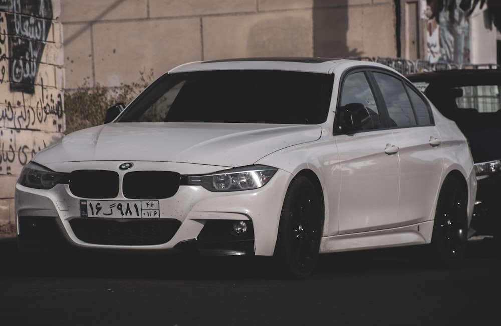 a white car parked on the side of a road