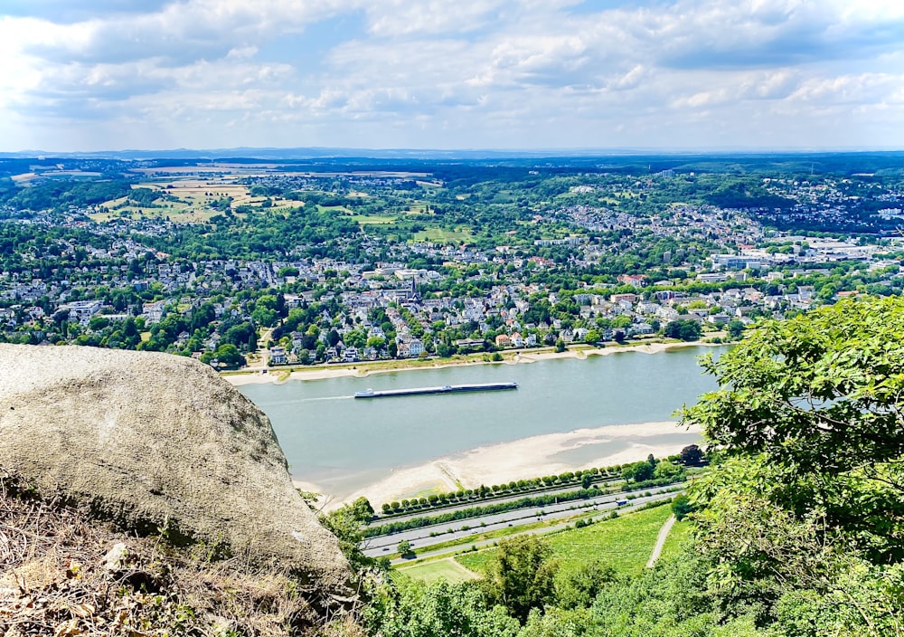 a body of water surrounded by trees and a city