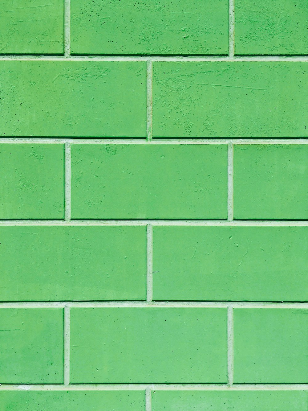 a close up of a green and white tile