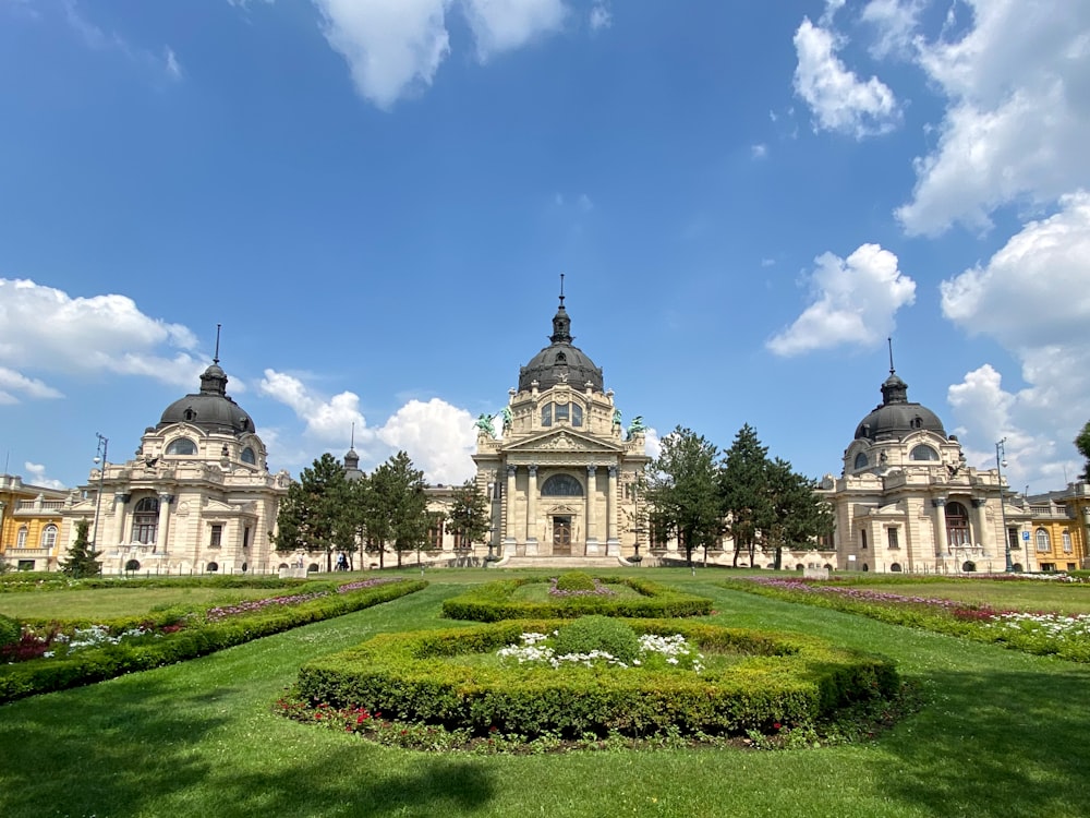 a large building with a garden in front of it