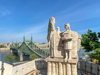 a stone statue on a bridge