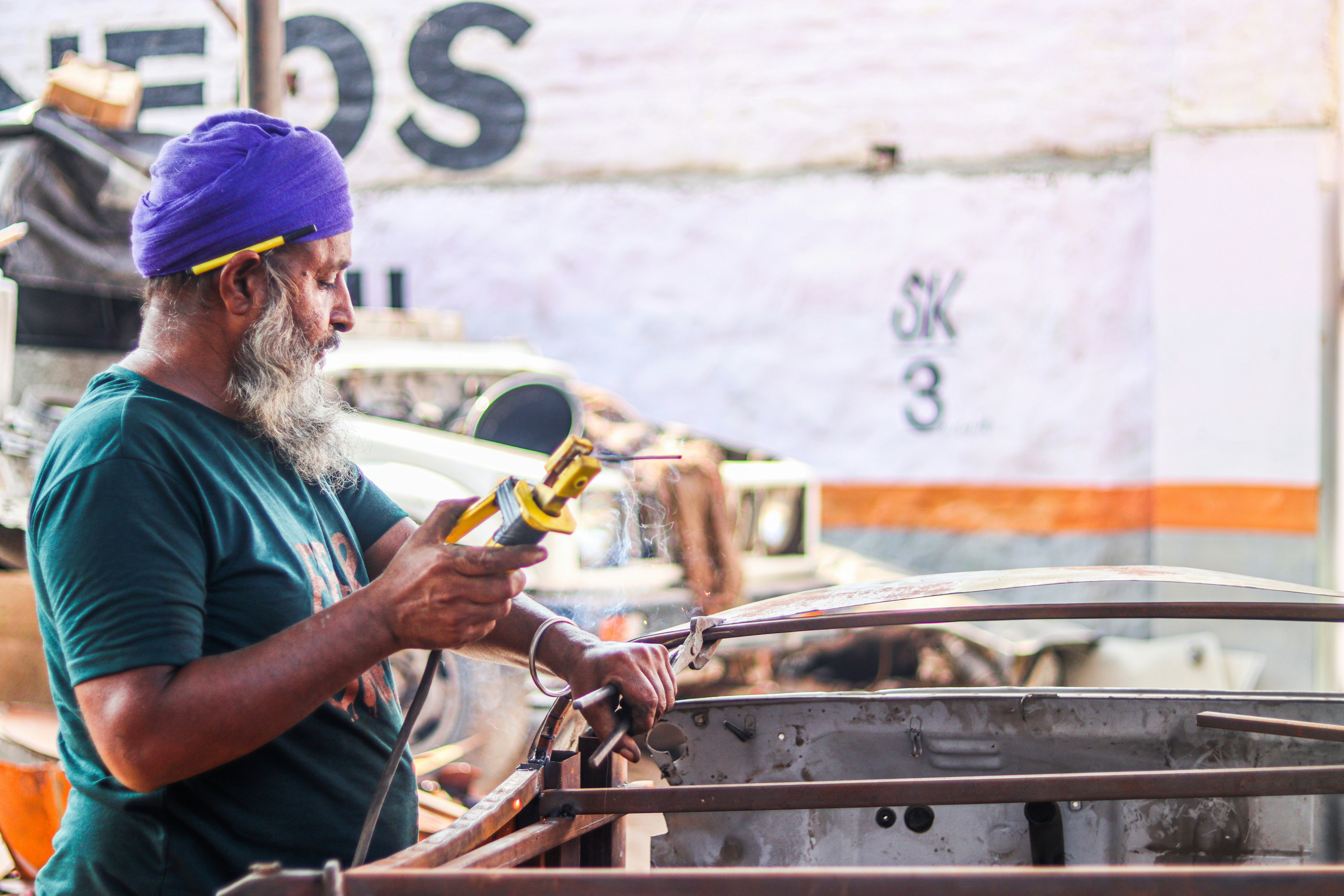 Auto body shop owner reviewing digital marketing metrics on a tablet in a garage