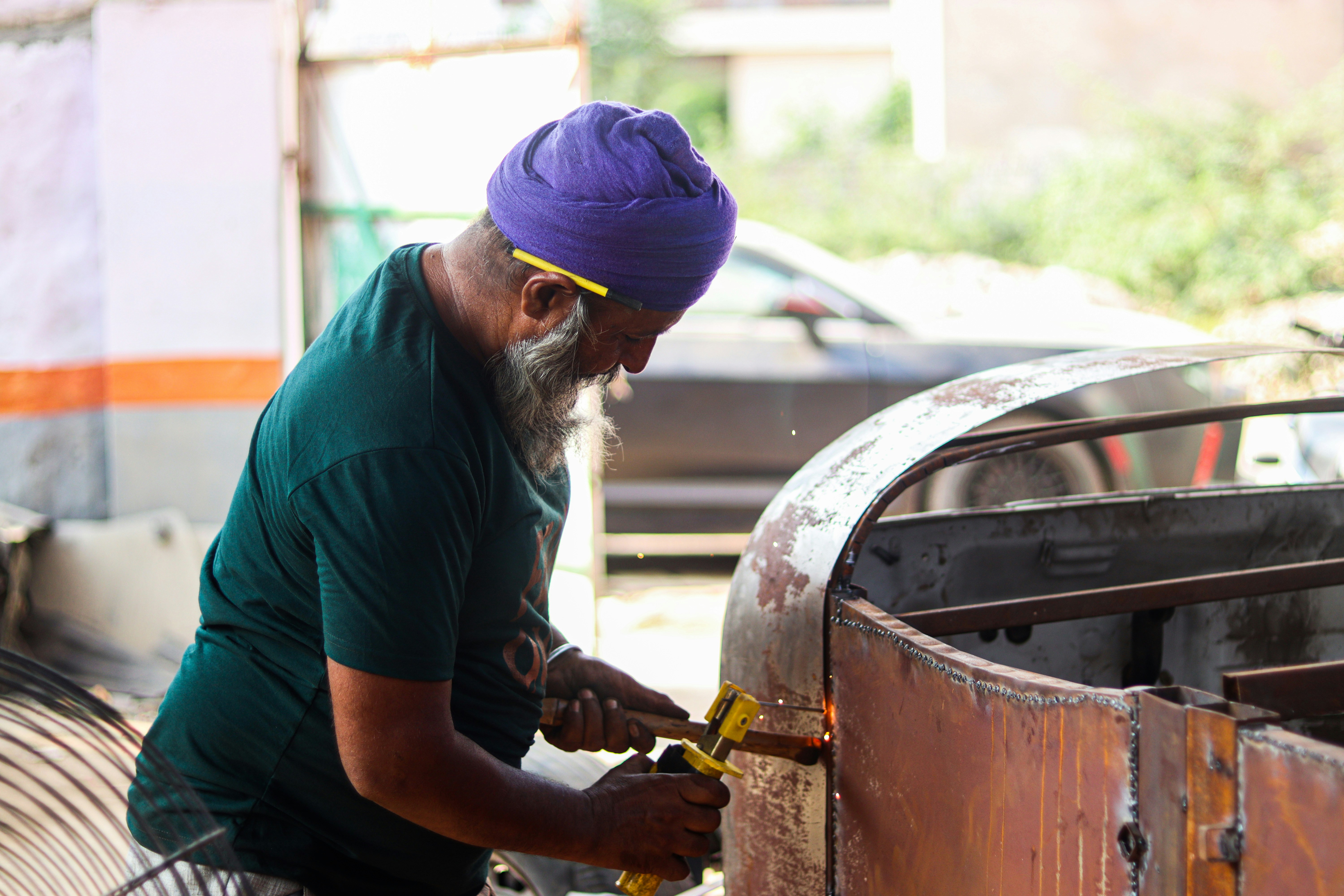 a man with a beard working on a car