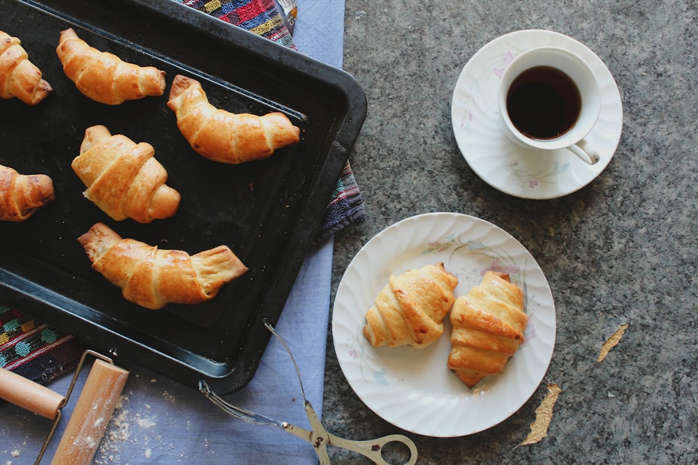 a plate of pastries and a cup of coffee on a grill