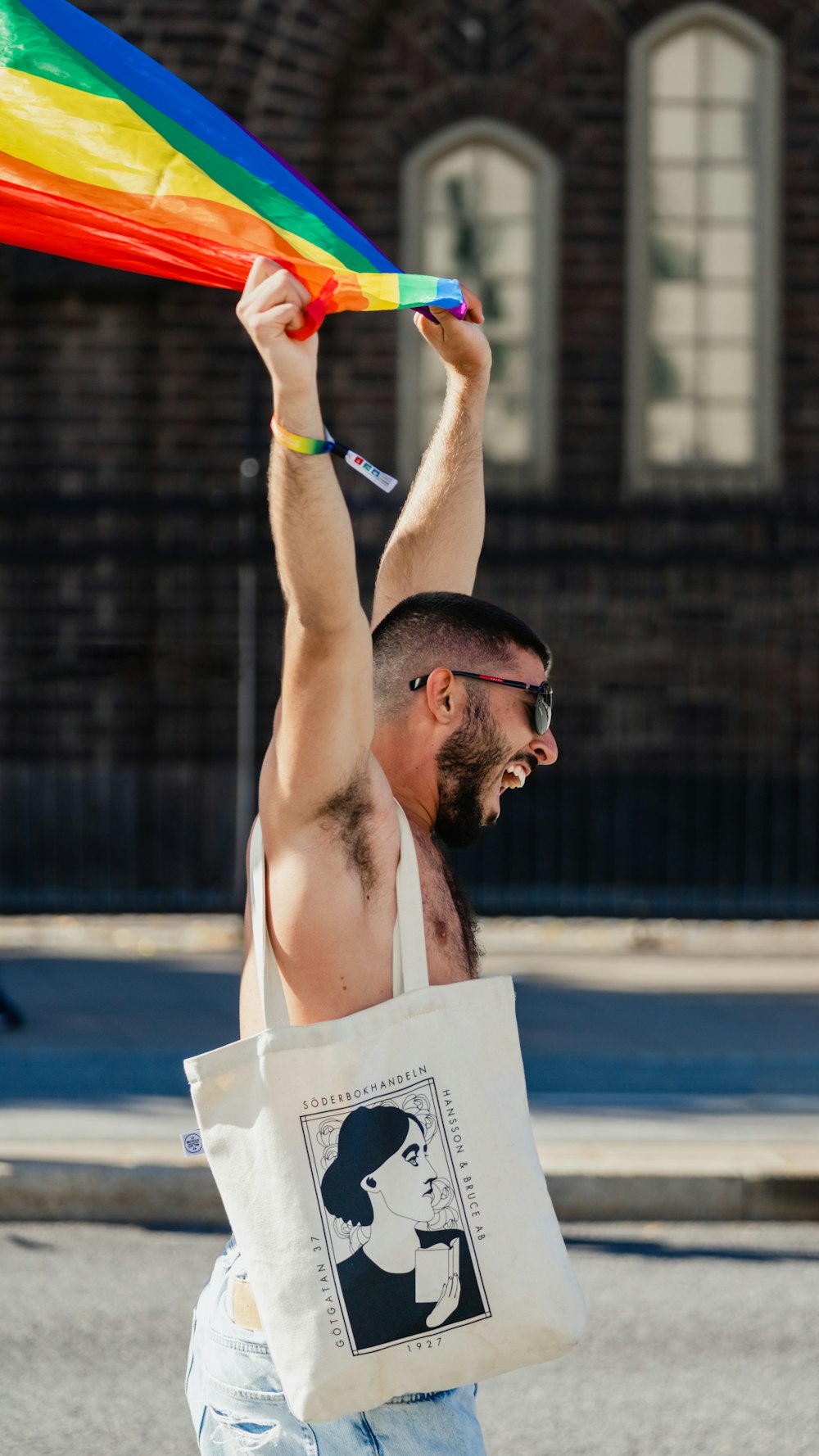 a person holding a rainbow flag