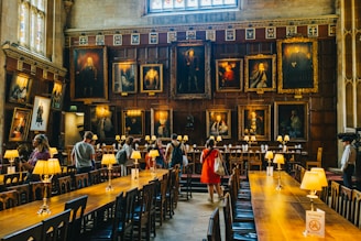 a group of people in a room with art on the walls