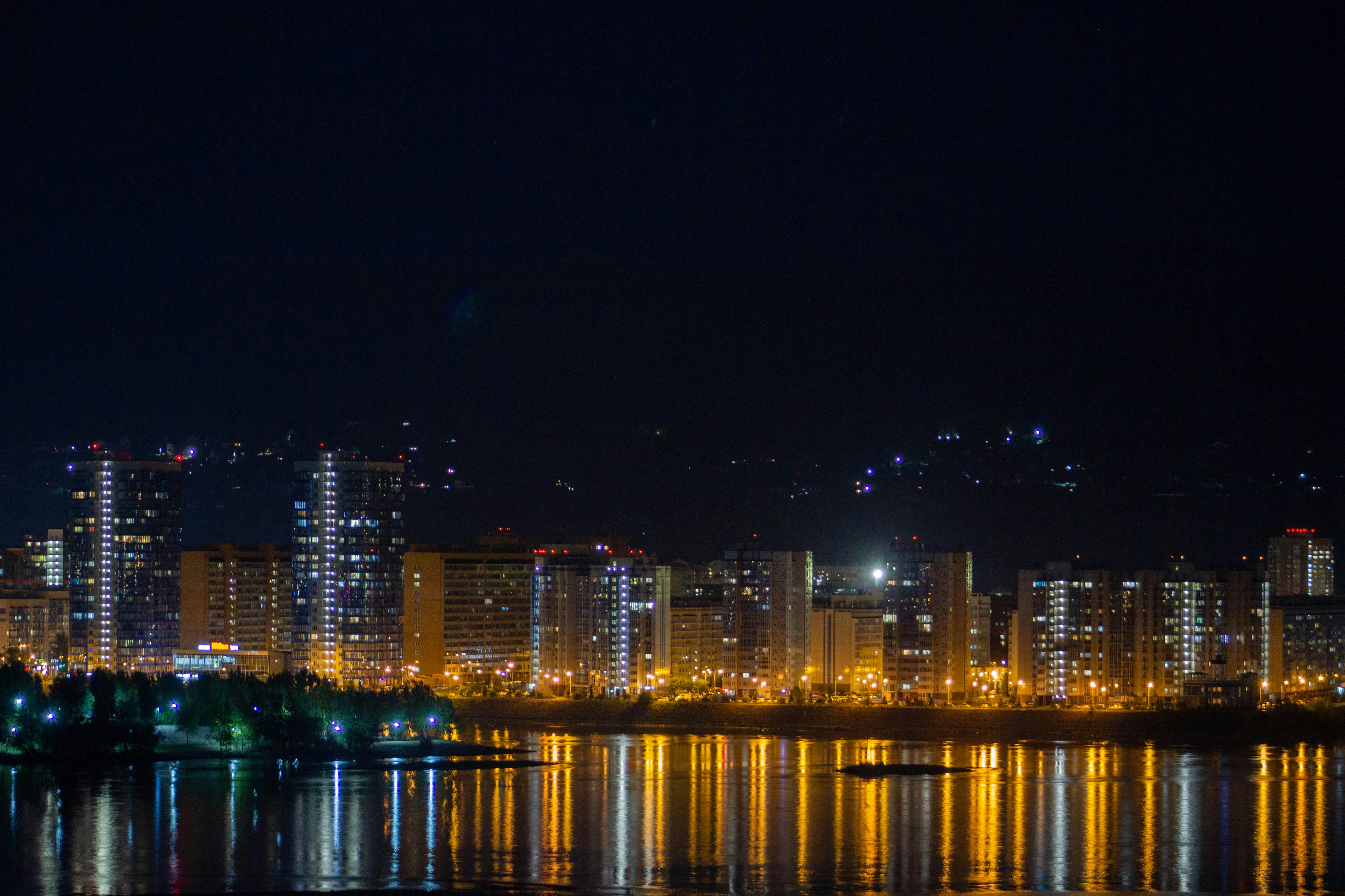 A city skyline at night photo – Free Brown Image on Unsplash