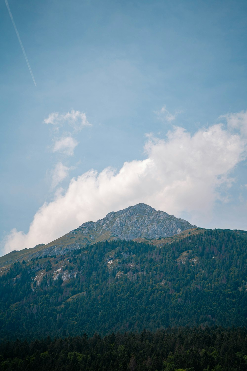 a mountain with clouds above it