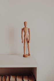 a wooden sculpture on a shelf