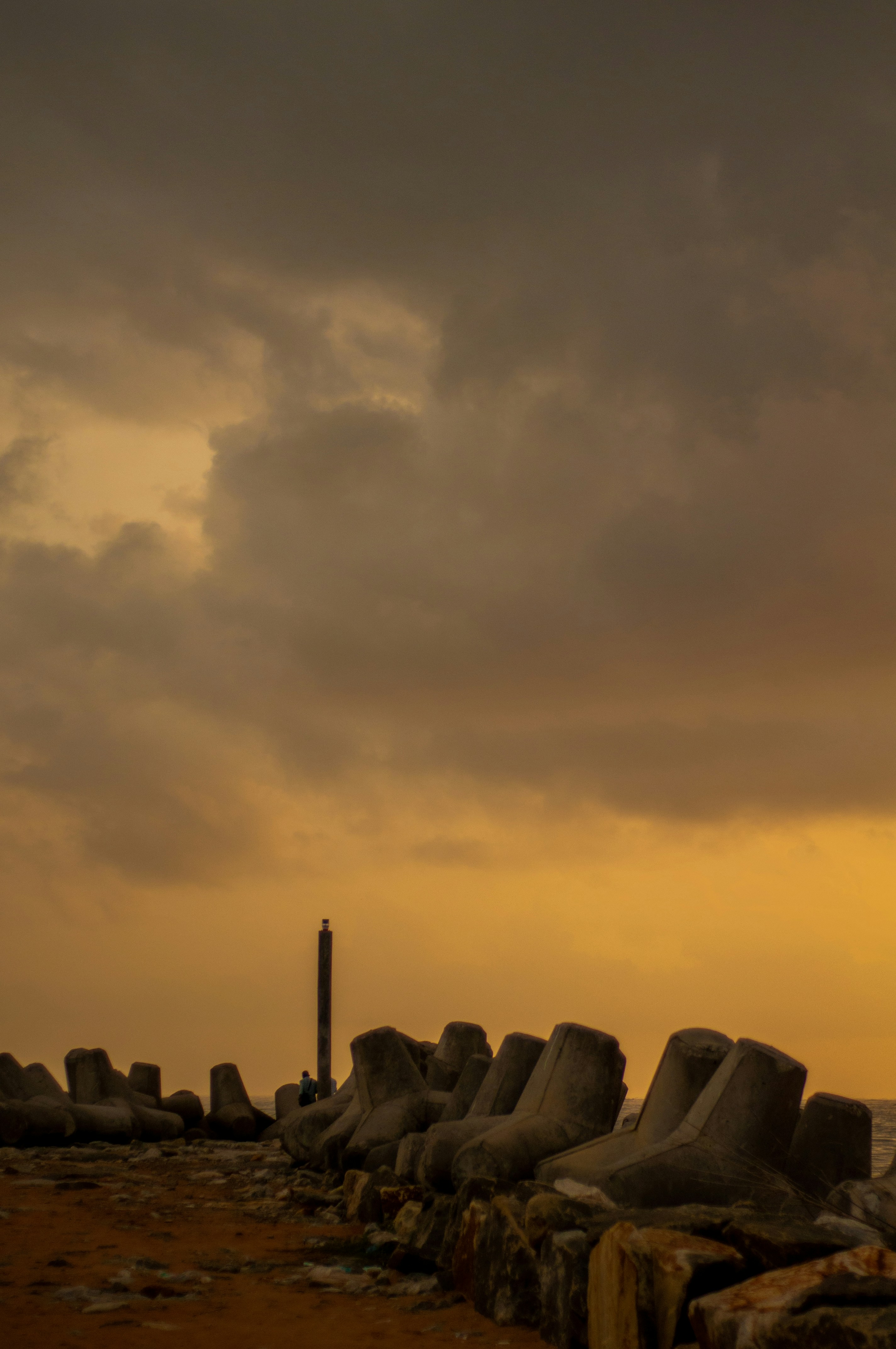 a group of rocks with a tower in the background