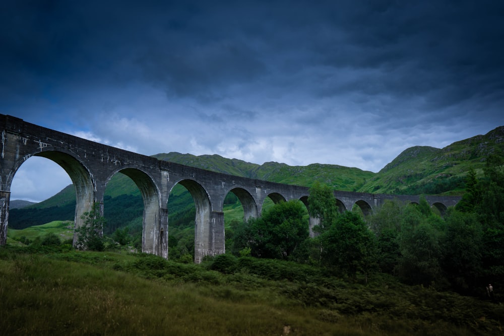 a large bridge over a grassy hill