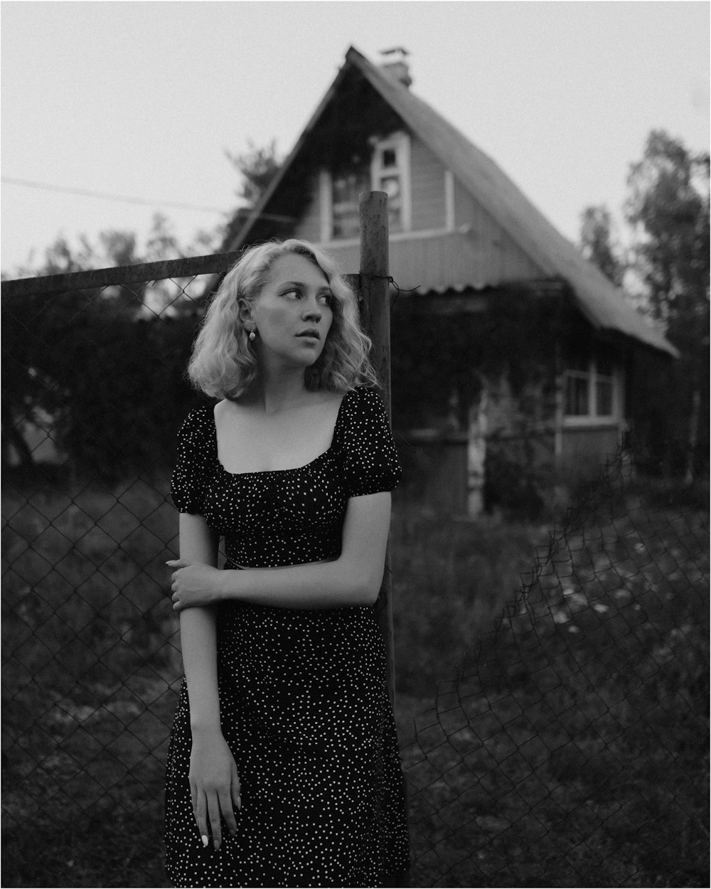 a woman standing in front of a house