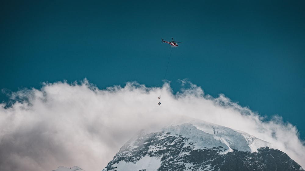 a helicopter flying over a mountain